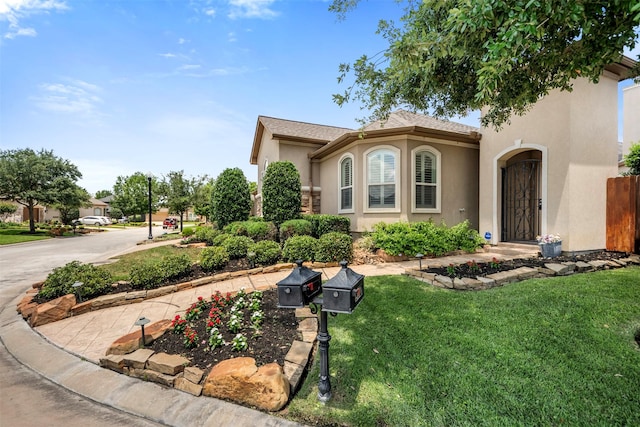 13614 Boerne Canyon Ln, Cypress, TX 77429 - mediterranean / spanish house featuring stucco siding, a front lawn, and driveway