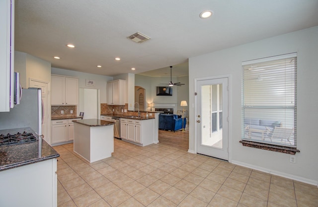 18611 Camellia Estates Ln, Cypress, TX 77429 - kitchen with visible vents, dishwasher, open floor plan, ceiling fan, and backsplash
