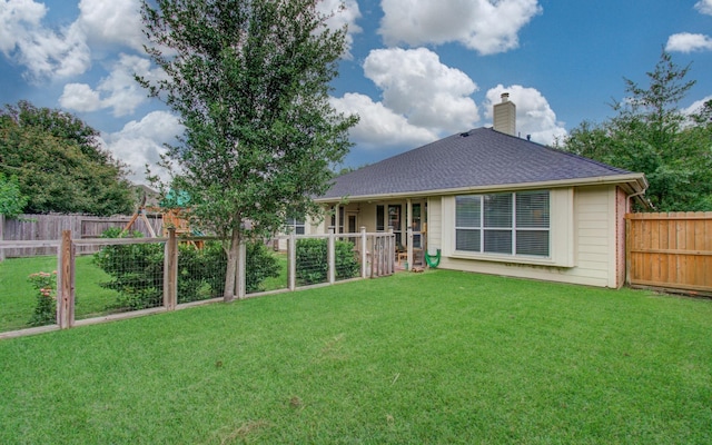 18611 Camellia Estates Ln, Cypress, TX 77429 - rear view of property featuring a fenced backyard, roof with shingles, a yard, and a chimney