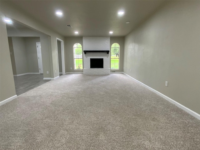 unfurnished living room featuring carpet flooring, recessed lighting, baseboards, and visible vents