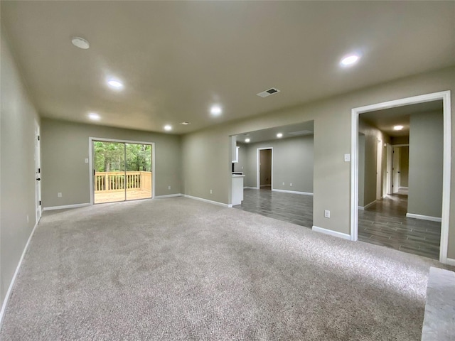 empty room with carpet floors, recessed lighting, baseboards, and visible vents