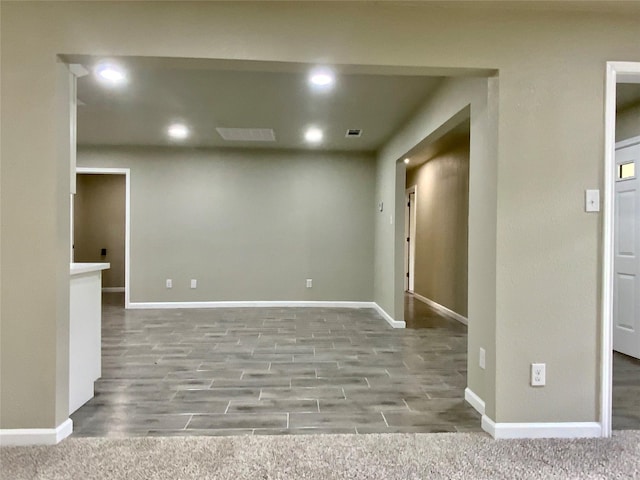 unfurnished room with baseboards, recessed lighting, and wood finished floors