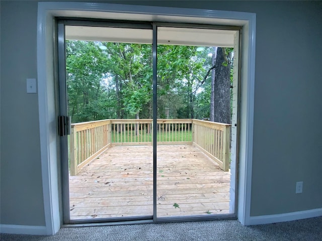 entryway featuring a healthy amount of sunlight, baseboards, and carpet floors
