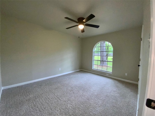 spare room with baseboards, carpet, and ceiling fan