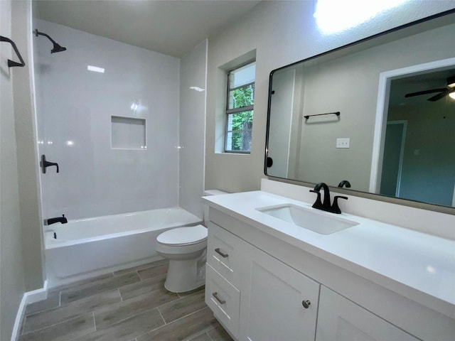 bathroom featuring ceiling fan, vanity, toilet, shower / bath combination, and wood tiled floor