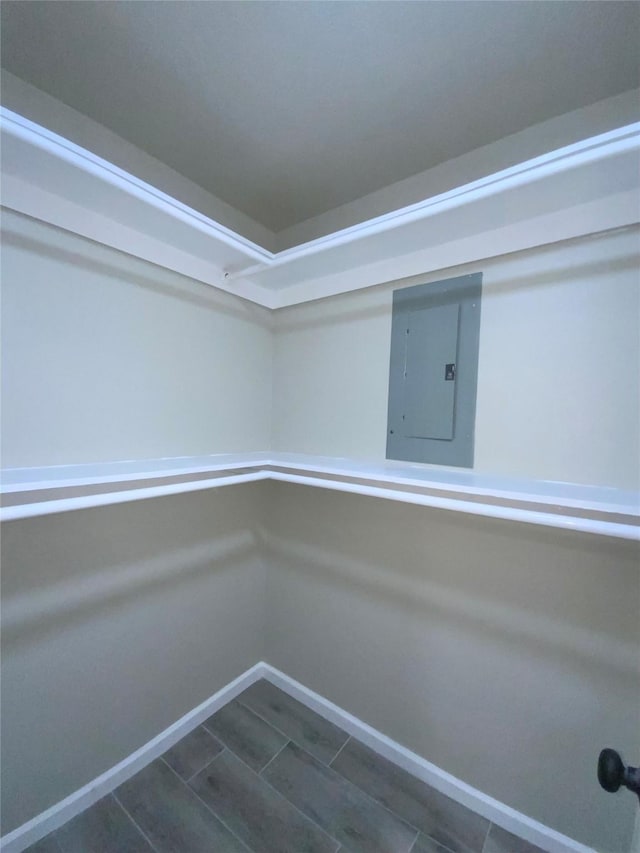 interior space with baseboards and electric panel