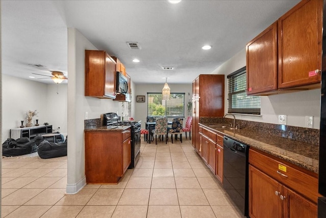 kitchen featuring a sink, light tile patterned floors, black appliances, and visible vents