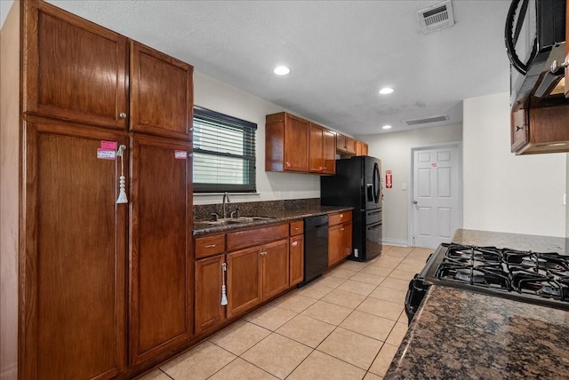 kitchen featuring light tile patterned flooring, a sink, recessed lighting, visible vents, and black appliances