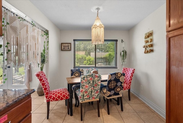 dining space featuring baseboards and light tile patterned floors