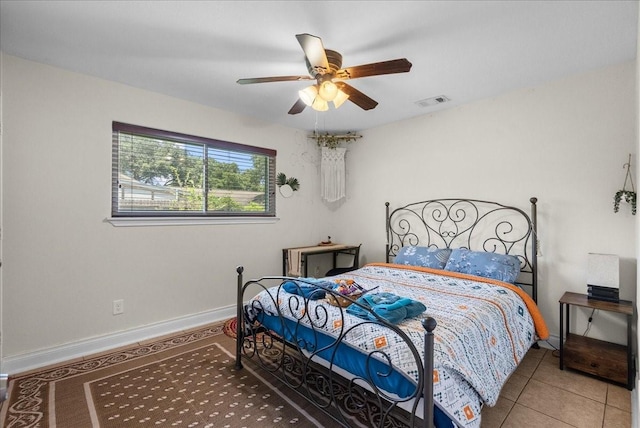 tiled bedroom with visible vents, baseboards, and ceiling fan