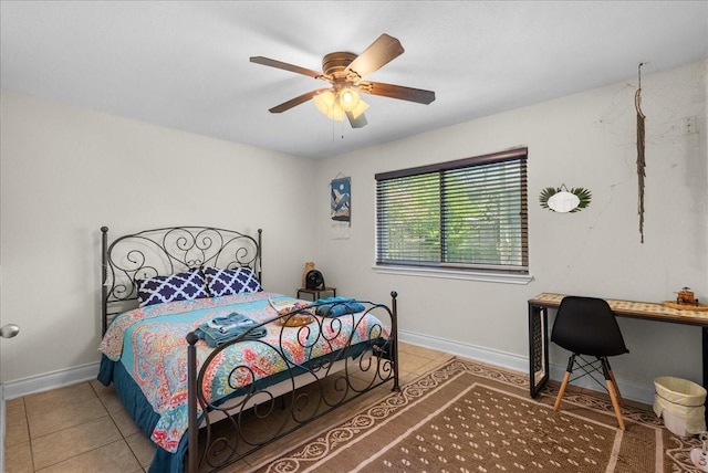 bedroom with light tile patterned floors, baseboards, and a ceiling fan