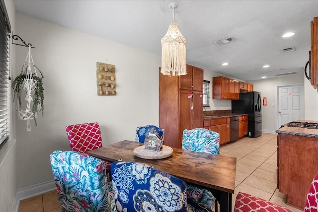 dining room with baseboards, visible vents, and light tile patterned floors