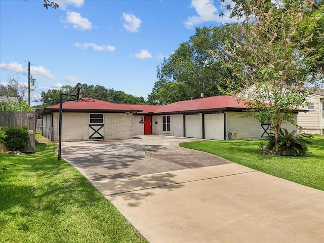 ranch-style home with fence, brick siding, a garage, a front yard, and concrete driveway