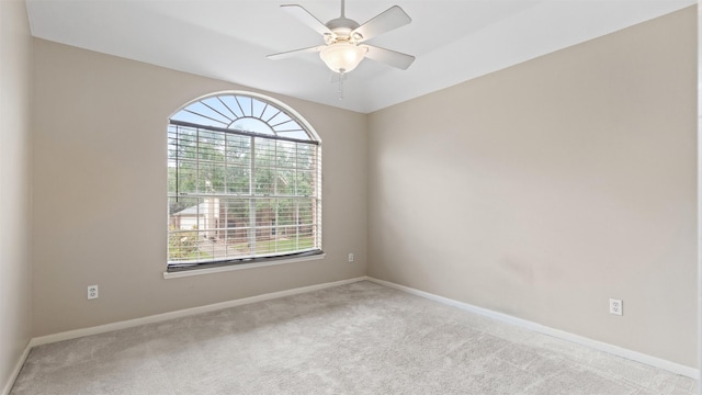 empty room featuring carpet, ceiling fan, and baseboards