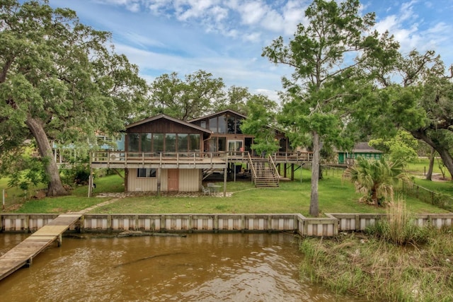6348 County Road 659, Brazoria, TX 77422 - rear view of house featuring a lawn, a sunroom, stairs, and a deck with water view