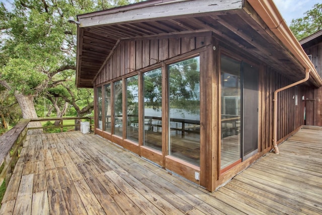 6348 County Road 659, Brazoria, TX 77422 - wooden deck with a sunroom and a water view