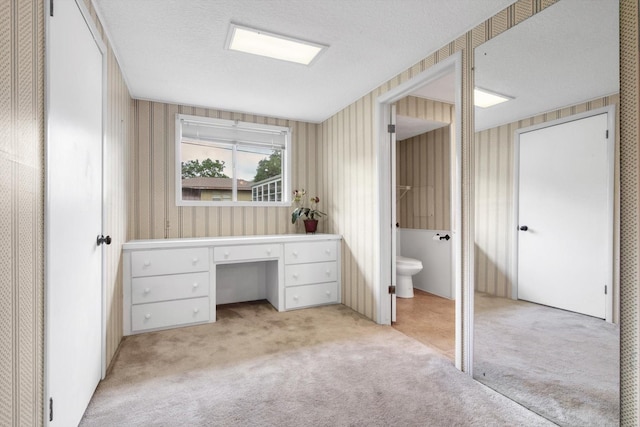 6348 County Road 659, Brazoria, TX 77422 - bathroom featuring carpet flooring, a textured ceiling, toilet, and wallpapered walls