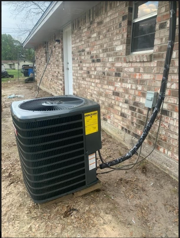 details featuring central AC unit and brick siding