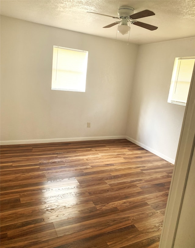 empty room featuring a textured ceiling, ceiling fan, and wood finished floors
