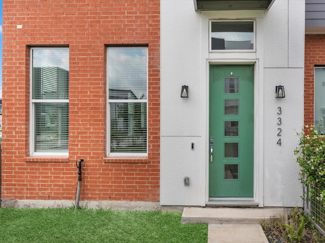 property entrance with brick siding