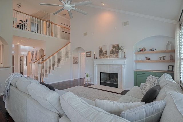 1307 Romero Dr, Pearland, TX 77581 - living area with stairs, wood finished floors, visible vents, arched walkways, and a ceiling fan