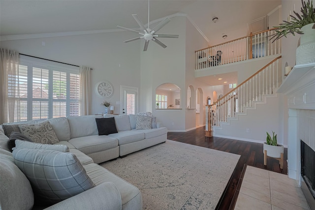 1307 Romero Dr, Pearland, TX 77581 - living room featuring ceiling fan, stairs, arched walkways, and plenty of natural light