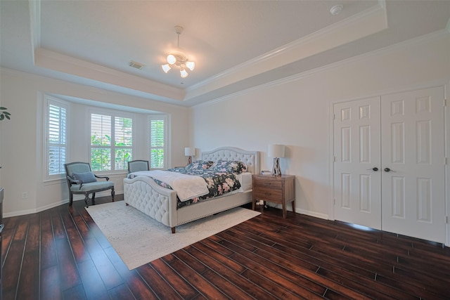 1307 Romero Dr, Pearland, TX 77581 - bedroom featuring dark wood finished floors, visible vents, baseboards, and a raised ceiling