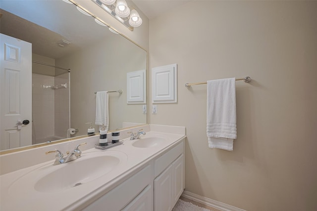 1307 Romero Dr, Pearland, TX 77581 - full bath with double vanity, visible vents, baseboards, and a sink