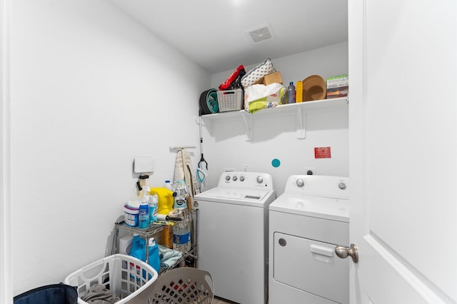 laundry area featuring visible vents, laundry area, and washer and clothes dryer