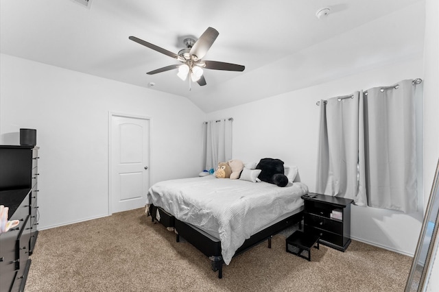 carpeted bedroom with baseboards, ceiling fan, and vaulted ceiling