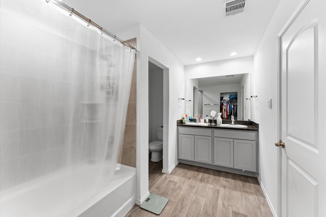 full bath featuring vanity, toilet, baseboards, wood finished floors, and visible vents