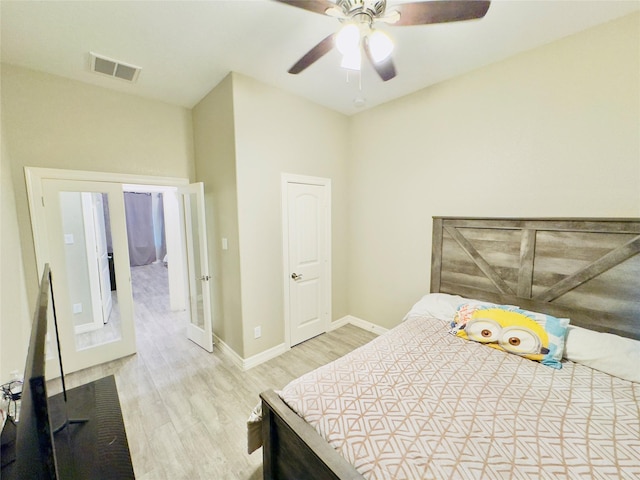 bedroom with ceiling fan, baseboards, visible vents, and wood finished floors