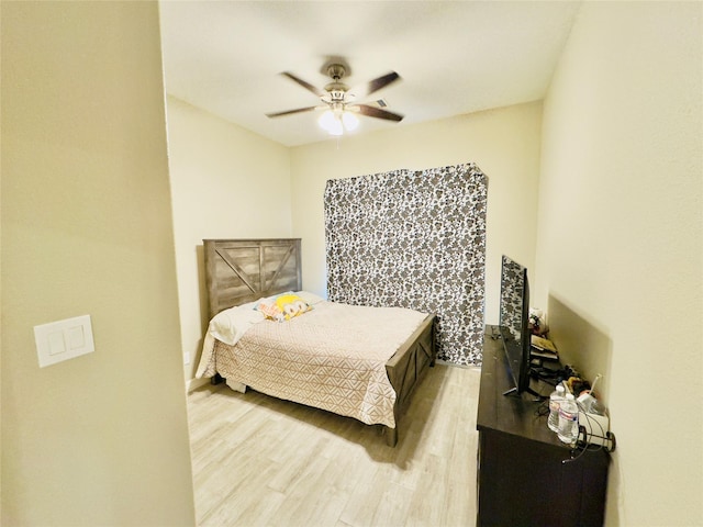 bedroom with ceiling fan and light wood-style floors