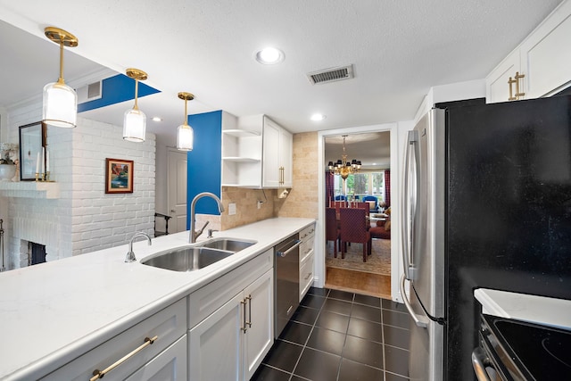 8944 Chatsworth Dr, Houston, TX 77024 - kitchen featuring open shelves, a notable chandelier, appliances with stainless steel finishes, a sink, and visible vents