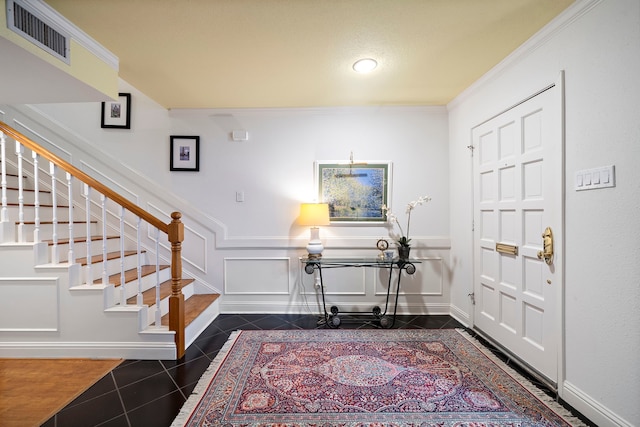 8944 Chatsworth Dr, Houston, TX 77024 - entrance foyer with visible vents, baseboards, crown molding, and stairs