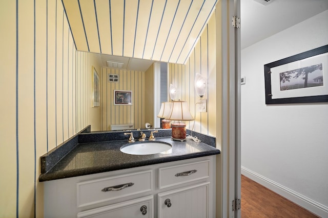 8944 Chatsworth Dr, Houston, TX 77024 - half bath with baseboards, vanity, toilet, and wood finished floors