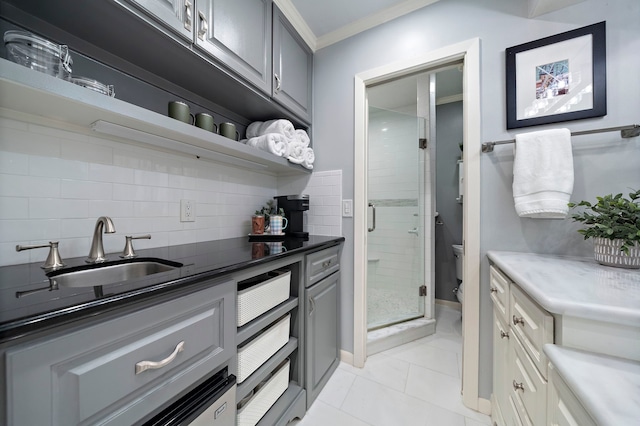 8944 Chatsworth Dr, Houston, TX 77024 - kitchen featuring crown molding, open shelves, a sink, gray cabinets, and decorative backsplash