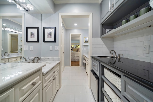 8944 Chatsworth Dr, Houston, TX 77024 - ensuite bathroom with backsplash, crown molding, tile patterned flooring, vanity, and ensuite bath