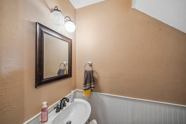 bathroom featuring a sink and wainscoting