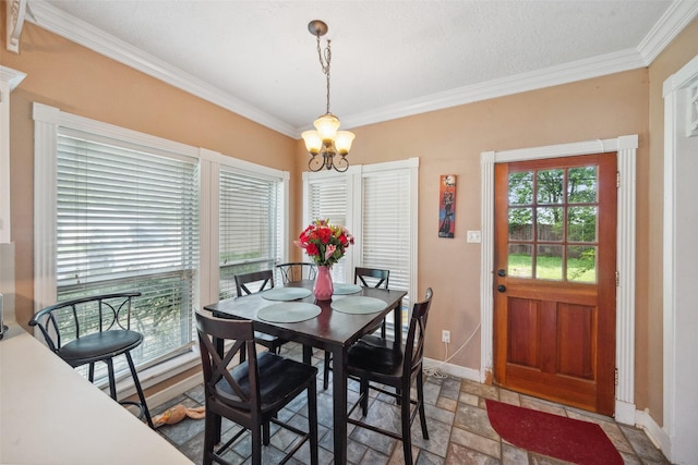 dining space featuring crown molding, baseboards, a notable chandelier, and stone finish floor