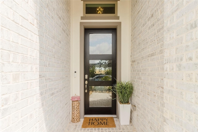 property entrance with brick siding