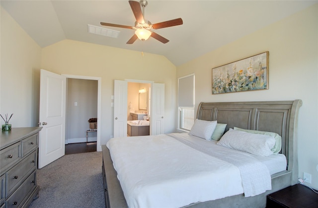 bedroom featuring ceiling fan, ensuite bath, dark carpet, lofted ceiling, and visible vents