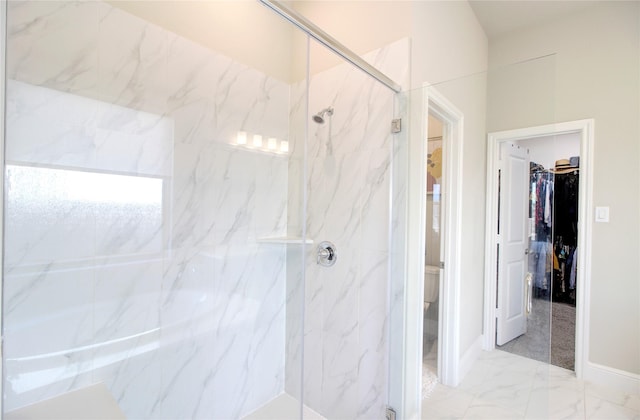 full bath featuring toilet, a spacious closet, a marble finish shower, and marble finish floor
