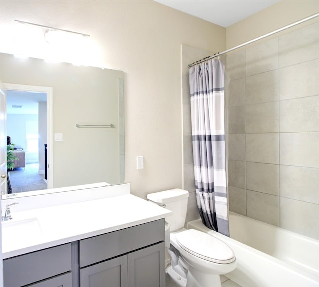 bathroom featuring vanity, shower / bath combo with shower curtain, and toilet