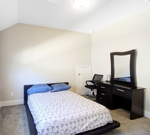 bedroom with baseboards, light colored carpet, and lofted ceiling