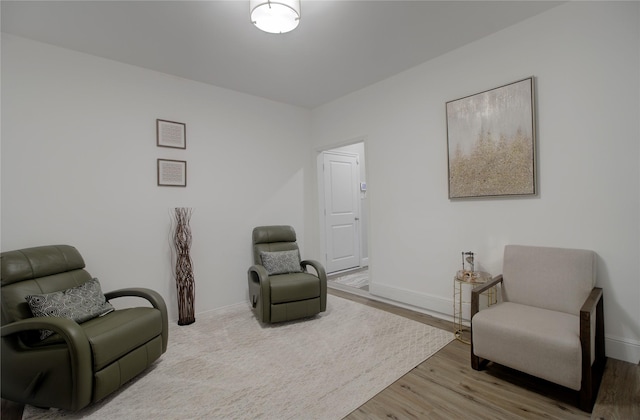 sitting room featuring baseboards and wood finished floors