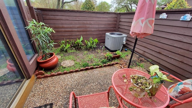 view of yard with central air condition unit and fence