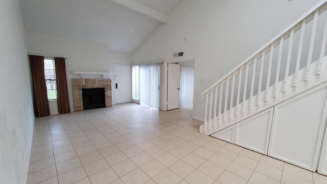 unfurnished living room with visible vents, stairs, beam ceiling, and a wealth of natural light