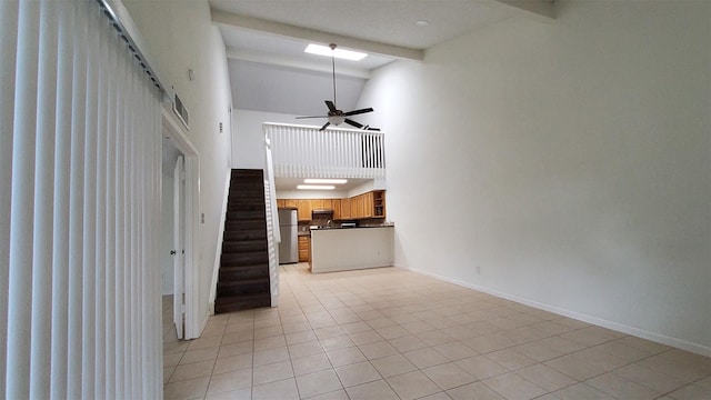unfurnished living room featuring light tile patterned flooring, beam ceiling, high vaulted ceiling, baseboards, and stairway
