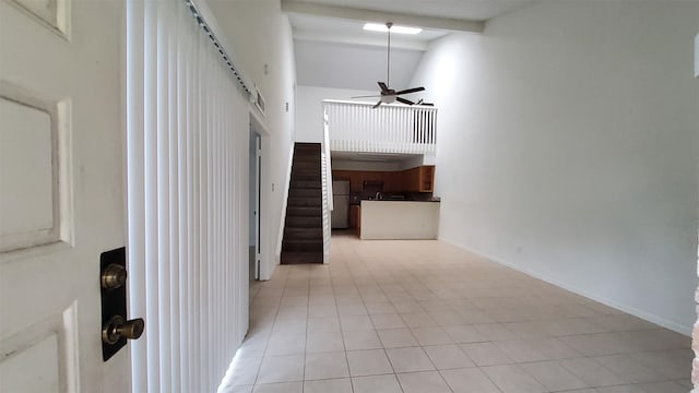 hall featuring light tile patterned flooring, high vaulted ceiling, baseboards, beamed ceiling, and stairway